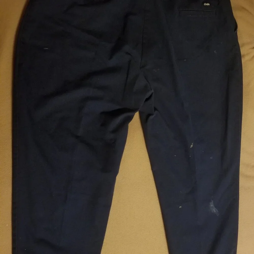 Three stained Cintas men's pants with stretching waistbands